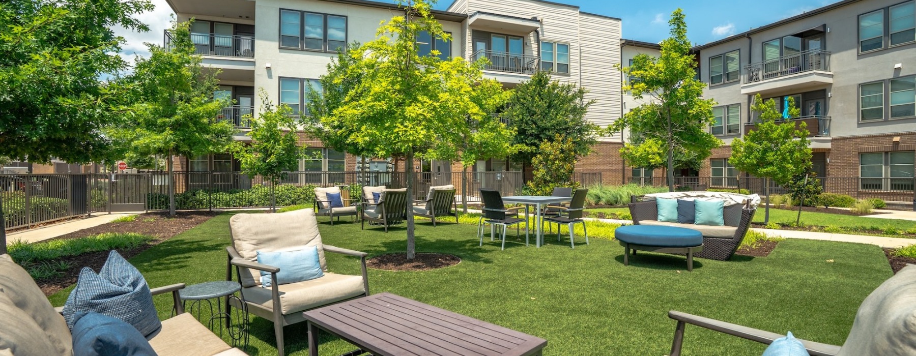 Outdoor courtyard with lounge seating and bar 