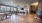 Lounge at our apartments in Flower Mound, featuring wood grain flooring, counter seating, and tables.