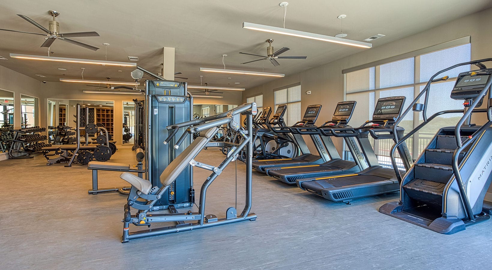 fitness center The fitness center at our apartments in Flower Mound, featuring free weights, treadmills, and more exercise equipment.